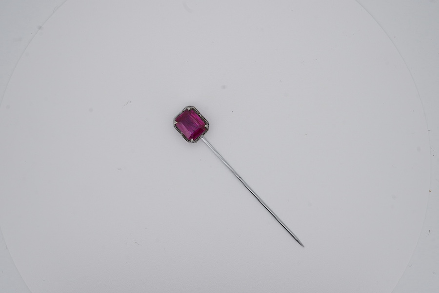 A North American? 10k white metal and single stone emerald cut synthetic ruby set stick pin, 55mm, gross weight 1.1 grams. Condition - fair to good